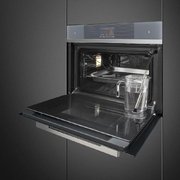 Компактный духовой шкаф с пароваркой Smeg SF4104WVCPS фото 2 в Новосибирске